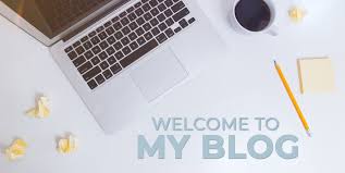 Flat lay of a laptop, coffee cup, pencil, and paper with the text "Welcome to My Blog"
