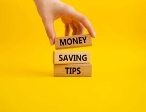 Three wooden blocks with the words "money," "saving," and "tips" written on them.