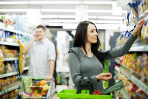 Couple engaged in mystery shopping, inspecting a store's customer service and products.